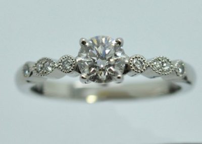 Platinum engagement ring accompanied with 6 small diamonds