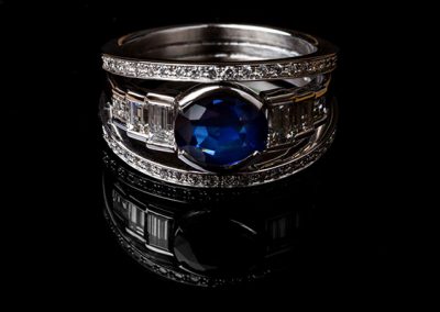 Sapphire diamond ring. In the center a frame with a drop of baguette diamonds. On both sides, two lines of diamonds