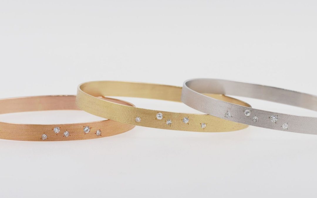 Trilogie de joncs en or blanc, or rose et or jaune, brossés et sertis de diamants